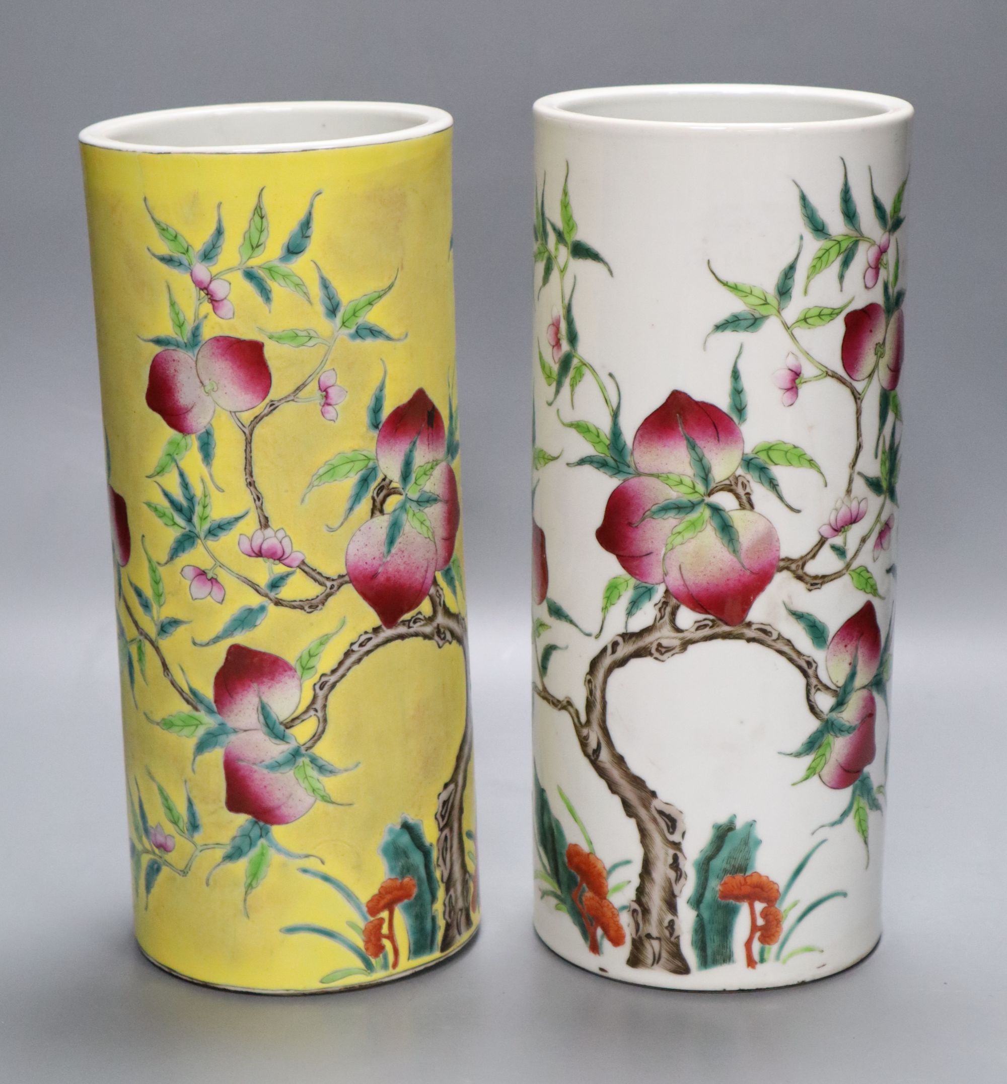 Two Chinese peaches and bats famille rose cylindrical vases, height 29cm